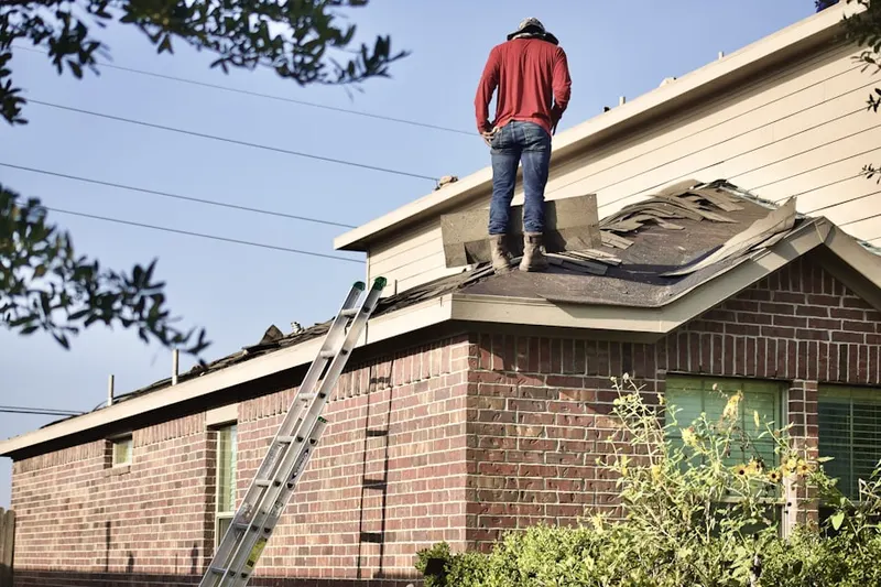 Professional roofer working on a residential roof in Fair Grove
